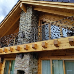 Artisitc forged railing with forest theme with pines on acottage balcony in High Tatras  exterior railings