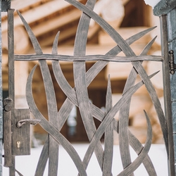 Forged gate with grass theme as apart of aremakable fencing of acabin  artistic gates and fences