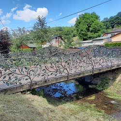 Hand-forged railing made as a barrier on a bridge over a stream