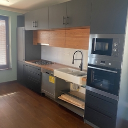 Overall view of the freshly installed kitchen cabinet with custom-made forged handles