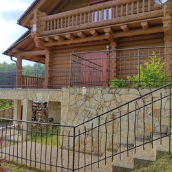 Forged exterior railing with apattern called BABIKA at acottage near Levoa