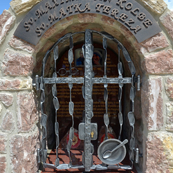 Forged monument of Saints with characteristic features: Glasses, Plate with a spoon