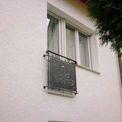 A wrought iron railing - a French window A wrought iron railing - a French window