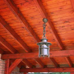 A wrought iron hanging light with a shade