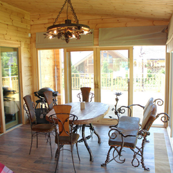 Enclosed summer house in mountain cottage with luxury wrought iron furniture, lighting and wrought iron accessories from UKOVMI Enclosed summer house in mountain cottage with luxury wrought iron furniture, lighting and wrought iron accessories from UKOVMI