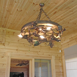 Stylish chandelier in enclosed summer house in mountain cottage  hand-wrought iron work of art with an UKOVMI seal