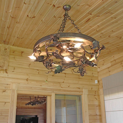 Stylish chandelier in enclosed summer house in mountain cottage – hand-wrought iron work of art with an UKOVMI seal Stylish chandelier in enclosed summer house in mountain cottage – hand-wrought iron work of art with an UKOVMI seal