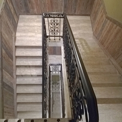 View of the stair railing from above - forged railing in the interior of the pension 