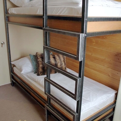 Moderná železná poschodová posteľ vyhotovená pre penzión