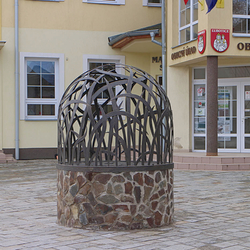 A wrought-iron dome for a well with a pattern of grass