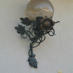 A wrought iron sunflower as a side lamp