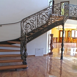 A wrought iron staircase with an exceptional interior railing