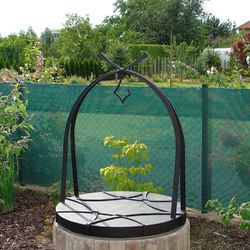 A wrought iron well cover