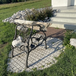 A hand-forged altar with a stone tablet near the cross in Frikovce