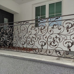 Forged exterior railing at afamily home entrance