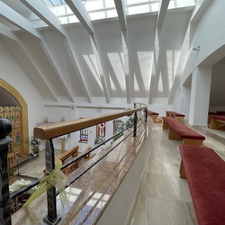 Wrought iron railing with wooden handrail on the gallery of the church