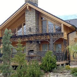 Forged patio roofing, railings with flower pots, outdoor lamps and luxury garden furniture on the terrace of the cottage Forged patio roofing, railings with flower pots, outdoor lamps and luxury garden furniture on the terrace of the cottage