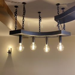 Aforged chandelier with vintage light bulbs and an adjustable chain  Astylish pendant lighting